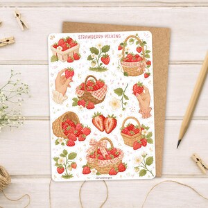 May include: A sticker sheet titled STRAWBERRY PICKING featuring various illustrations of red strawberries, woven baskets filled with fruit, strawberry plants with white flowers, and hands holding individual strawberries on a white background.