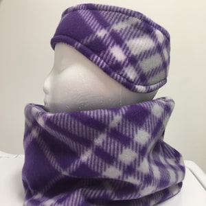 May include: A purple, white, and gray plaid fleece headband and neck gaiter set. The headband is designed to cover the ears, and the neck gaiter is a tube of fabric that can be worn around the neck or pulled up over the face.