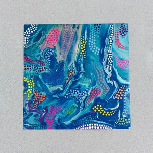 May include: Abstract art piece with a square shape. The artwork features a vibrant mix of colors, including shades of blue, pink, yellow, and orange. The design incorporates dotted patterns and flowing lines, creating a dynamic and visually engaging composition.