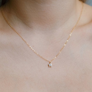 Delicate necklace with a small flower pendant