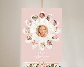 May include: A pink poster with a white daisy design featuring photos of a baby girl. The text "CHLOE my first year" is printed on the poster.