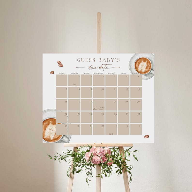 May include: A baby shower calendar with the text "Guess Baby's Due Date" in elegant script. The calendar features a neutral color palette with coffee cup illustrations and coffee beans. The calendar is displayed on a wooden easel.