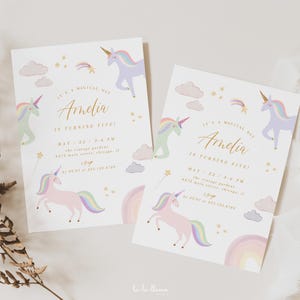 May include: Two pastel pink and purple unicorn birthday party invitations with gold lettering. The invitations say "It's a magical day Amelia is turning five!" with a date and time. The invitations are decorated with rainbows, stars, and clouds.