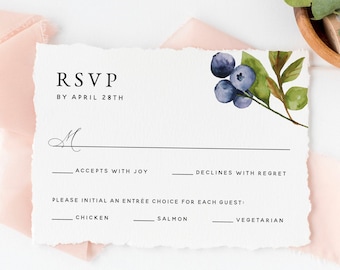 May include: RSVP card with a watercolor illustration of blueberries and leaves. The card has text that says "RSVP by April 28th" and includes options for accepting or declining the invitation, as well as a choice of chicken, salmon, or vegetarian for the meal.