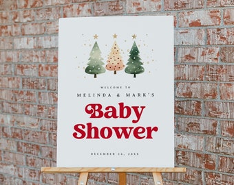 May include: White sign with a red and green Christmas tree design. The sign says "Welcome to Melinda & Mark's Baby Shower December 16, 20XX". The sign is on a wooden easel.