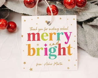 May include: A colorful Christmas gift tag with gold stars and the text "Thank you for making school merry and bright from: Asher Martin".