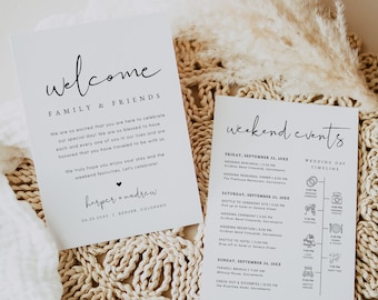 May include: A white welcome sign with black text that reads "Welcome Family & Friends" and includes the couple's names, wedding date, and location. A second white card with black text lists the weekend events, including a wedding ceremony, reception, and farewell brunch. The cards are on a woven straw mat.