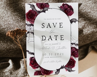 May include: A Save the Date card with a gothic theme. The card features a black and white oval frame with dark red roses, bats, and spiderwebs. The text reads "Til Death Do Us Part" and "Save the Date" with the wedding date and location.