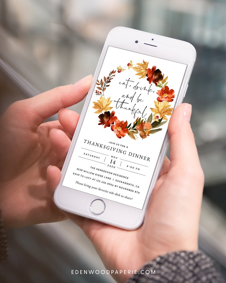 May include: A Thanksgiving dinner invitation on a smartphone screen with a wreath of fall leaves and flowers. The text reads "eat, drink, and be thankful." The invitation details include the date, time, location, and RSVP information.