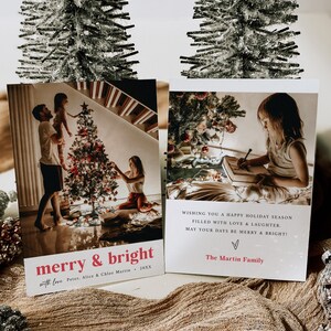 May include: A Christmas card featuring a photograph of a family decorating a Christmas tree. The card reads "merry & bright with love Peter, Alice & Chloe Martin, 20XX" and "WISHING YOU A HAPPY HOLIDAY SEASON FILLED WITH LOVE & LAUGHTER. MAY YOUR DAYS BE MERRY & BRIGHT! The Martin Family".
