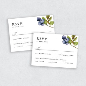 May include: RSVP card with a watercolor illustration of blueberries and leaves. The card has a section for guests to indicate their attendance and meal choice. The options are "Accepts with Joy", "Declines with Regret", "Chicken", "Salmon", and "Vegetarian".