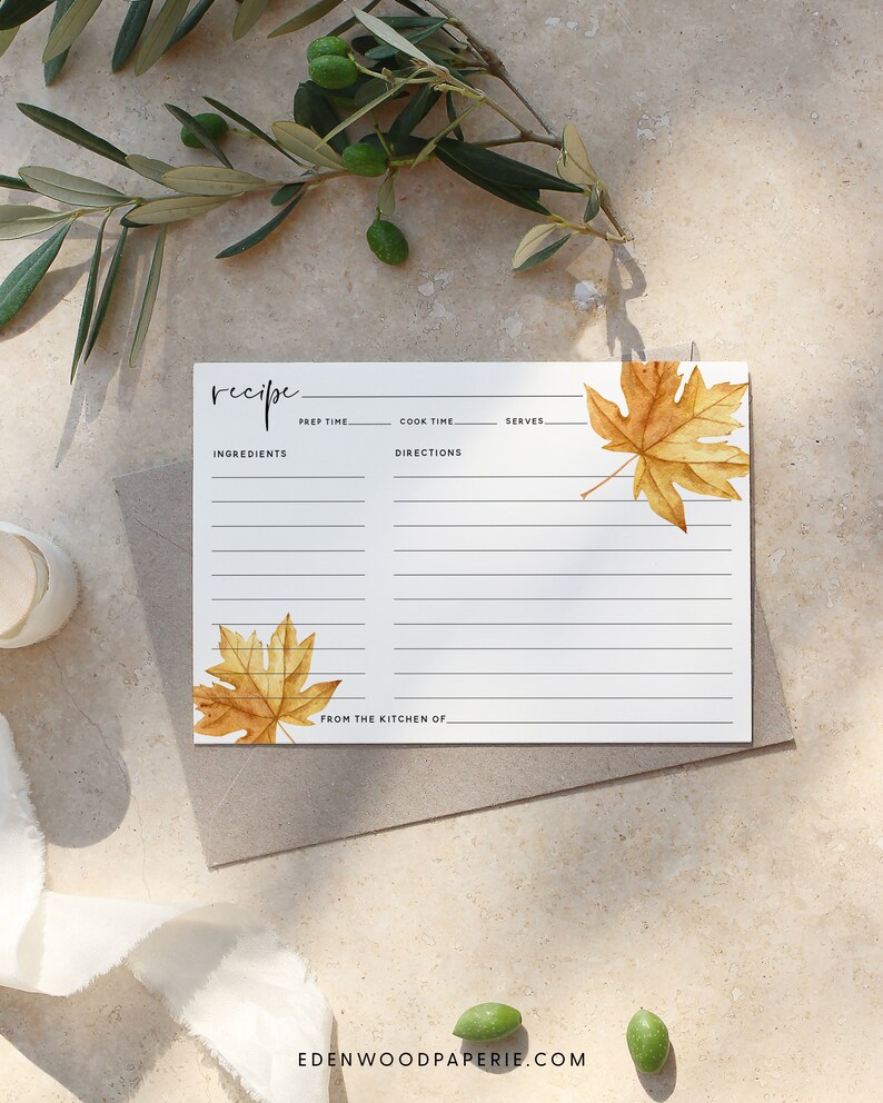 May include: A printable recipe card with a fall theme. The card has a white background with black lines for writing. The card is decorated with two watercolor illustrations of fall leaves in shades of orange and yellow. The text "recipe" is written in black at the top of the card. The text "from the kitchen of" is written at the bottom of the card.