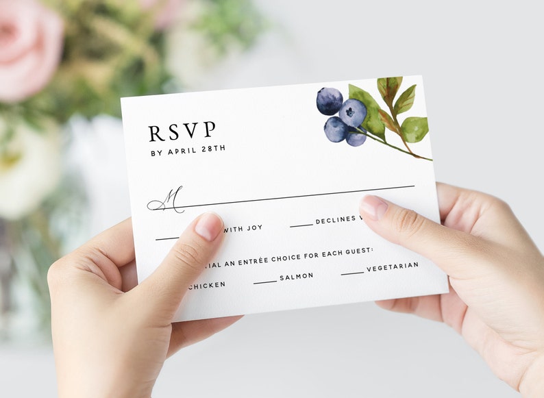 May include: RSVP card with a watercolor blueberry design. The card has a line for the guest's name, a checkbox for "with joy" and a checkbox for "declines". It also includes a section for the guest to choose their entree: chicken, salmon, or vegetarian.
