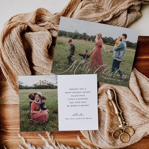 May include: A white Christmas card featuring a photograph of a family of four in a field. The card reads "Merry Christmas" in cursive script and "The Martin Family" underneath. The text "Wishing you a happy holiday season filled with love & laughter. May your days be merry & bright!" is printed below the photo. The card is signed "with love, Peter, Alice, Jacob & Lily Martin".