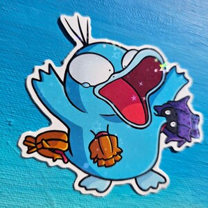 May include: A blue and purple cartoon character with a wide open mouth and large eyes. The character is holding a purple object in its right hand and a brown object in its left hand. The character is surrounded by white stars.