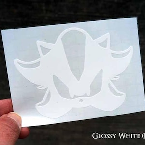 May include: White vinyl decal of Shadow the Hedgehog from the Sonic the Hedgehog video game series. The decal is on a white background.