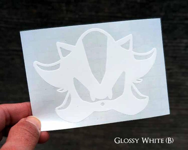 May include: White vinyl decal of Shadow the Hedgehog from the Sonic the Hedgehog video game series. The decal is on a white background.