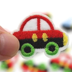 May include: Embroidered car patch with a red top, black body, and green wheels. The car has yellow headlights and a white border. This patch is suitable for decorating clothing or accessories.