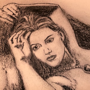 May include: A black and white charcoal drawing of a woman with long hair, wearing a necklace with a large gemstone pendant. The woman is lying down with her head resting on her hand.