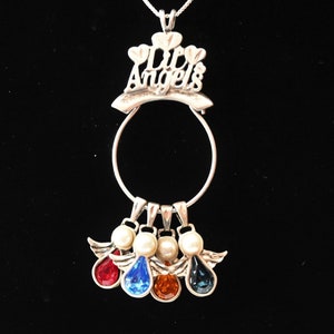 May include: Silver necklace with a charm that says "Life's Angels" and four angel charms with different coloured crystals.