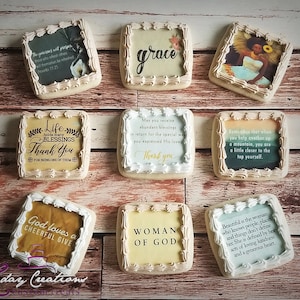 May include: Nine decorated sugar cookies with various inspirational quotes and images. The cookies are square shaped and have a white icing border. The quotes include "The generous will prosper", "Life holds many blessings", "May you receive abundant blessings", "Remember that when you help another up a mountain", "God loves a cheerful give", "Woman of God", and "Beautiful is the woman who knows people, places and things don't define her".