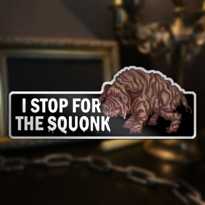 May include: A black and white sticker with the text "I Stop For The Squonk" and a cartoon illustration of a brown, wrinkly, mythical creature.