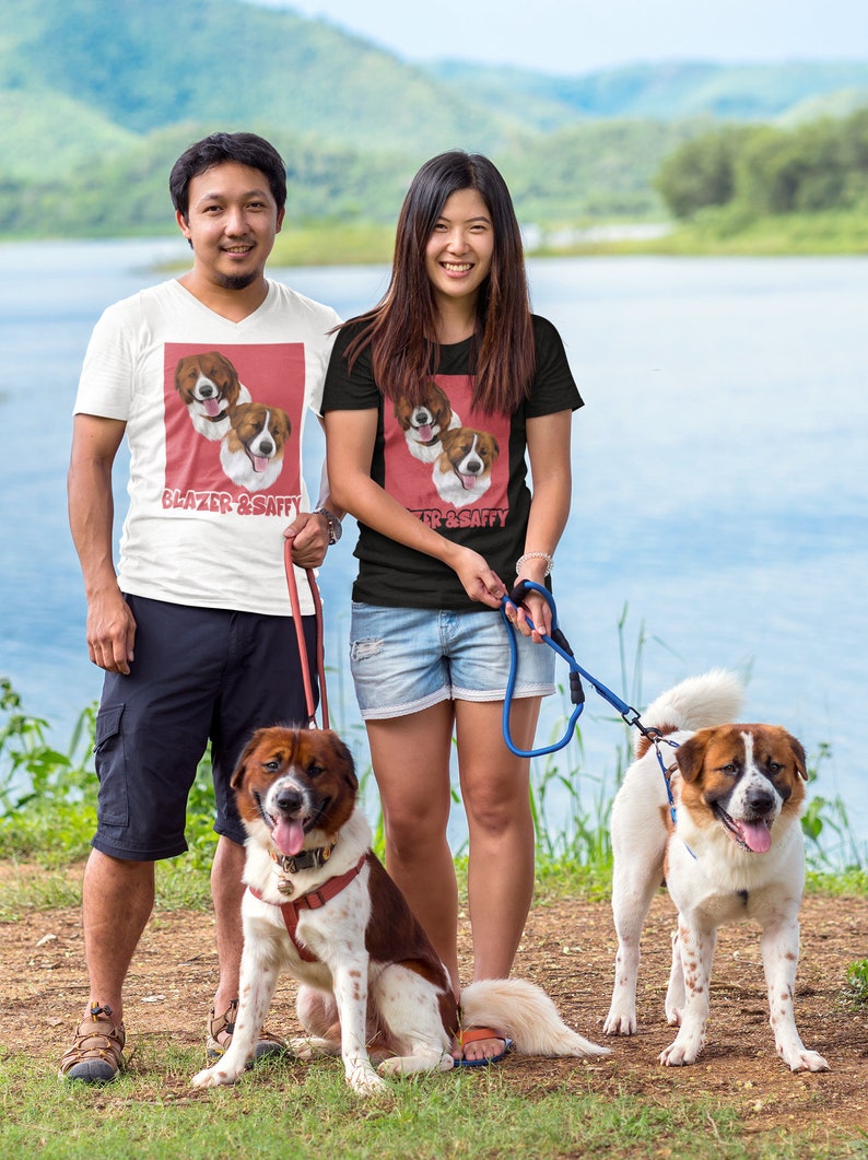 A couple wearing a custom pet t-shirt 
theman is wearing a white custing pet t-shirt and the woman is wearing a black custom pet t-shirt 
The couples are holding TWO AKITA bernard breed dogs
Couples wearing bernard custom pet t-shirt