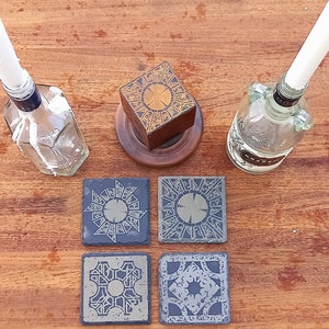 Laser-engraved Hellraiser puzzle-box pattern slate coasters.
