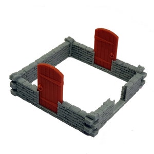 Puede incluir: Un recinto cuadrado de piedra en miniatura con dos puertas de madera de color marr&oacute;n rojizo con parte superior arqueada y tiradores de anilla. Los muros grises tienen una textura de ladrillo y forman un per&iacute;metro parcial con una entrada.