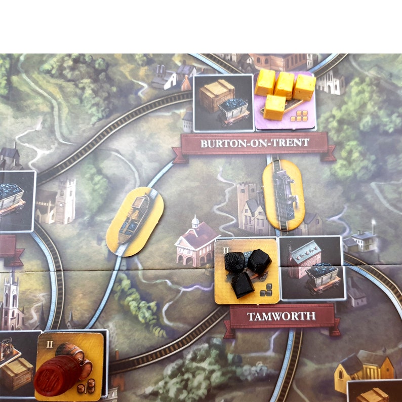 May include: A board game with a map of a train route. The game pieces include a train, coal, and wood. The towns of Burton-on-Trent and Tamworth are labeled on the map.