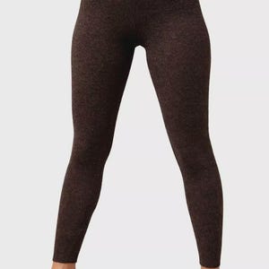 May include: Brown leggings with a ribbed texture. The full-length leggings are made of a soft, form-fitting material. The leggings are a solid brown color and are suitable for casual wear.
