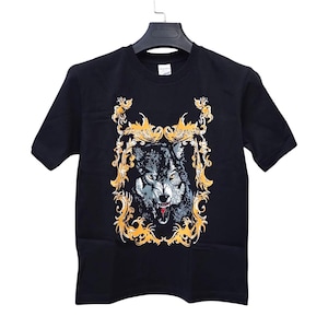 May include: Black t-shirt featuring a detailed illustration of a wolf with an open mouth, set within an ornate gold frame. The wolf's fur is rendered in shades of gray and white, with red accents on its tongue. The design is centered on the shirt.