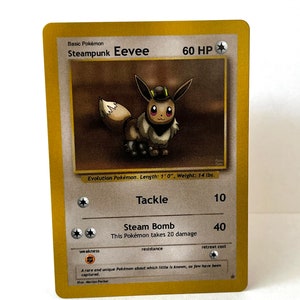 May include: A gold Pokémon trading card featuring a steampunk-themed Eevee with a brown and black mechanical helmet. The card has a gold background and features the text "Steampunk Eevee" and "60 HP".