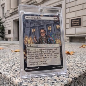 May include: A Smothering Tithe trading card encased in a clear plastic magnetic holder. The card features an illustration of a horned figure in a suit standing before the Department of Revenue & Mana Taxation, with text detailing enchantment rules.