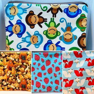 May include: Four different fabric designs for zippered pouches. The first design features a white background with colorful monkeys and a repeating pattern. The second design features a yellow background with a repeating pattern of squirrels, hedgehogs, and other woodland creatures. The third design features a blue background with a repeating pattern of red strawberries. The fourth design features a blue background with a repeating pattern of red and white foxes.