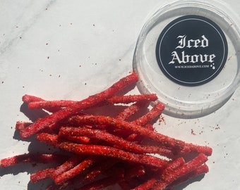 Sour strawberry straw candy coated in gourmet homemade chamoy and spices