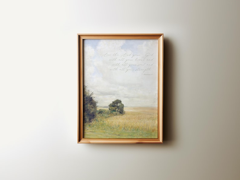 May include: A framed print with a landscape scene of a field with a tree and a cloudy sky. The print includes the text "Love the Lord your God with all your heart and with all your soul and with all your strength." - Deuteronomy 6:5