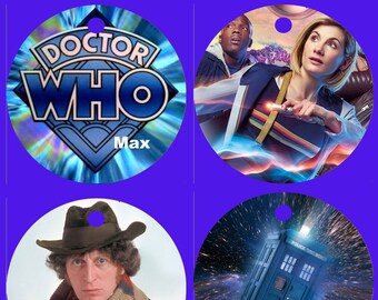 May include: Four round ornaments featuring Doctor Who themes. The first ornament has a blue and silver holographic background with the words "Doctor Who" in white and the word "Max" in white at the bottom. The second ornament features a blue and red background with a woman and a man in the background. The woman is holding a sonic screwdriver. The third ornament features a man wearing a brown hat and a scarf. The fourth ornament features a blue police box against a black background with white stars.