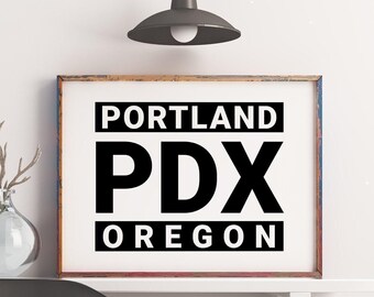 May include: A rectangular wall art print in a weathered brown frame featuring the black text PORTLAND, PDX, and OREGON on a white background. The design is centered with the word PORTLAND at the top, the large letters PDX in the middle, and OREGON at the bottom.