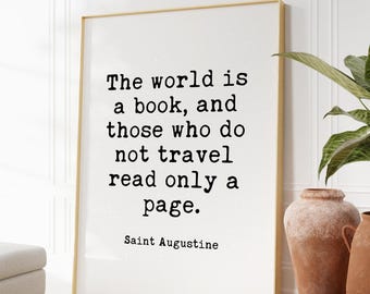 May include: A rectangular framed wall art piece featuring the black text: The world is a book, and those who do not travel read only a page. Saint Augustine. The frame is thin and light-colored, surrounding a white background with a subtle speckled texture.