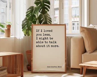 May include: A rectangular framed wall art piece featuring a cream-colored background with black typewriter-style text that reads: If I loved you less, I might be able to talk about it more. The bottom right corner includes the text Jane Austen, Emma.