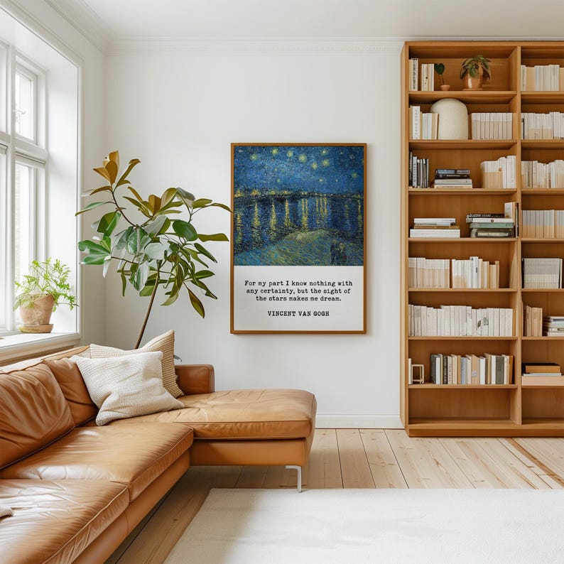 a cozy living room with a brown leather sofa, a large bookshelf filled with books, and a framed painting of a starry night sky hanging on the wall.