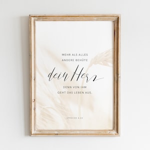 May include: A framed print with a beige background and a quote in black text: "More than all else, guard your heart, for everything you do flows from it." Proverbs 4:23