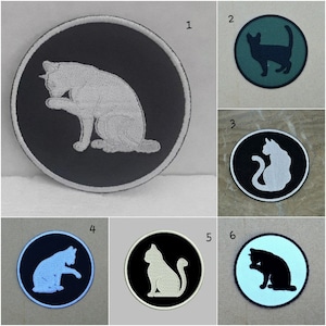 May include: Six round iron-on patches featuring different colored cats. The cats are in various poses, including sitting, lying down, and grooming. The patches are perfect for adding a touch of personality to clothing, bags, or other accessories.