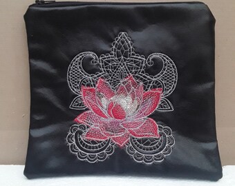 May include: Black zippered pouch with a red and silver embroidered lotus flower design.