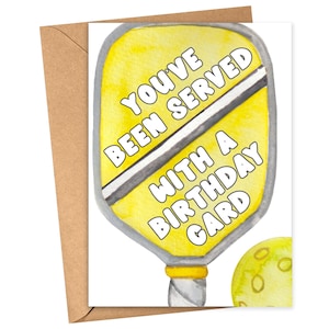 May include: A yellow and white birthday card with a paddleball and the text "You've Been Served With A Birthday Card".