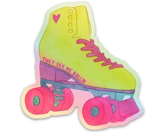 May include: A yellow roller skate with pink wheels and a pink heart on the side. The skate has the text "They See Me Rollin'" written on the side.