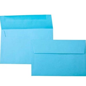May include: Two light blue envelopes, one slightly larger than the other, are stacked on top of each other. The envelopes are made of a smooth, textured paper.