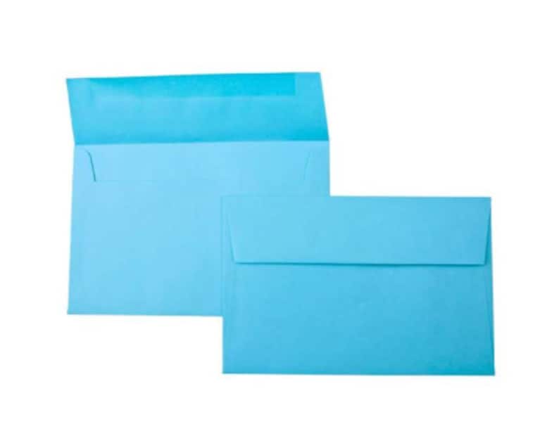 May include: Two light blue envelopes, one slightly larger than the other, are stacked on top of each other. The envelopes are made of a smooth, textured paper.