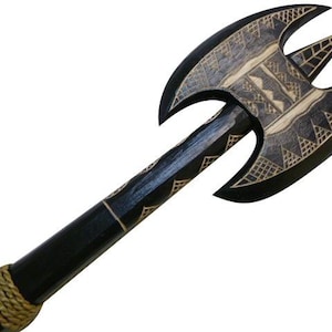 May include: A black wooden axe with a carved geometric design. The axe has a black handle wrapped in brown rope.